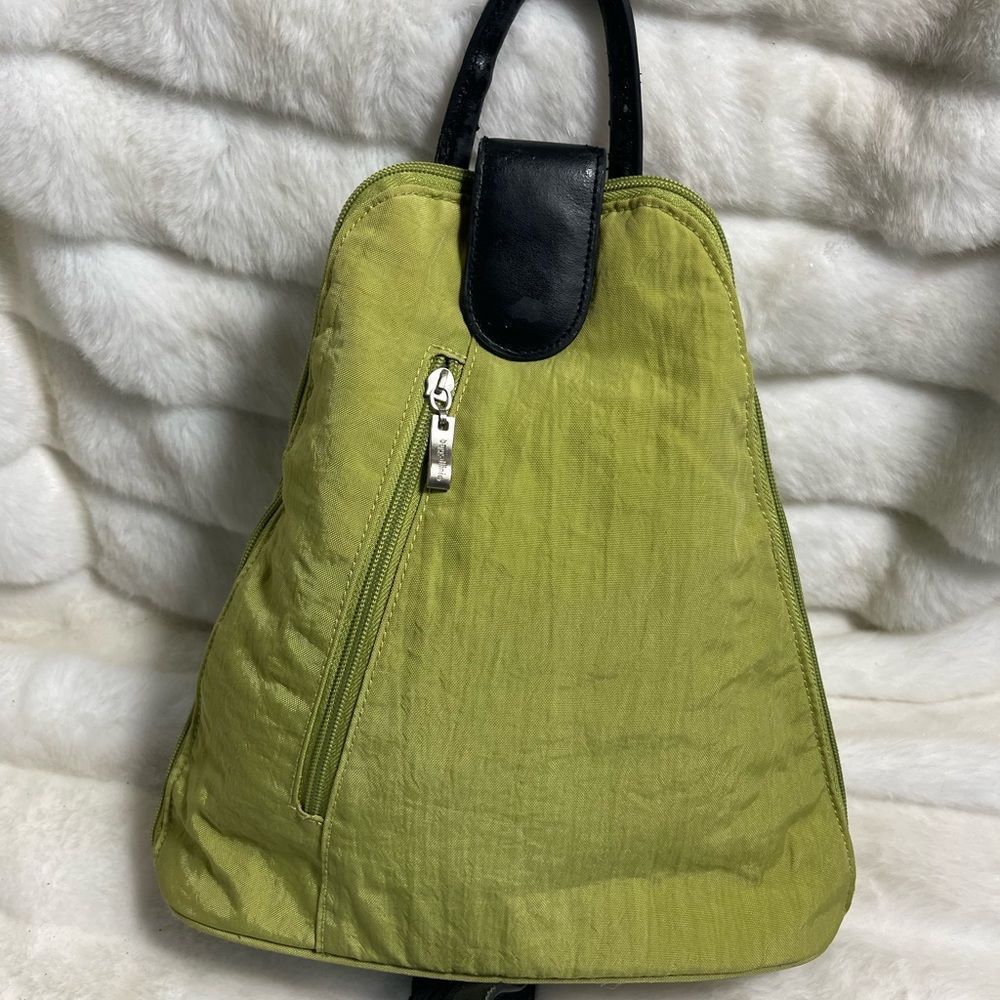 Baggallini green fabric small backpack/sling back with black straps and trims.